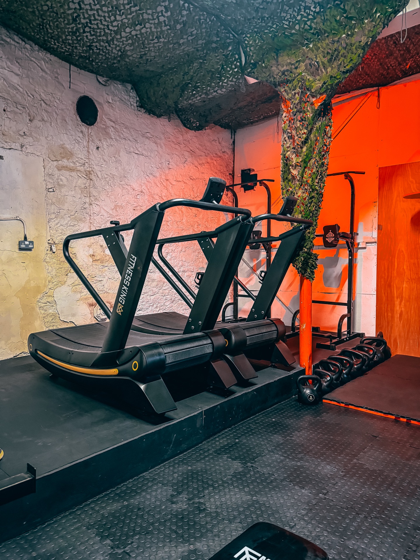 Curved treadmills and pull-up rig in the Genjitsu gym