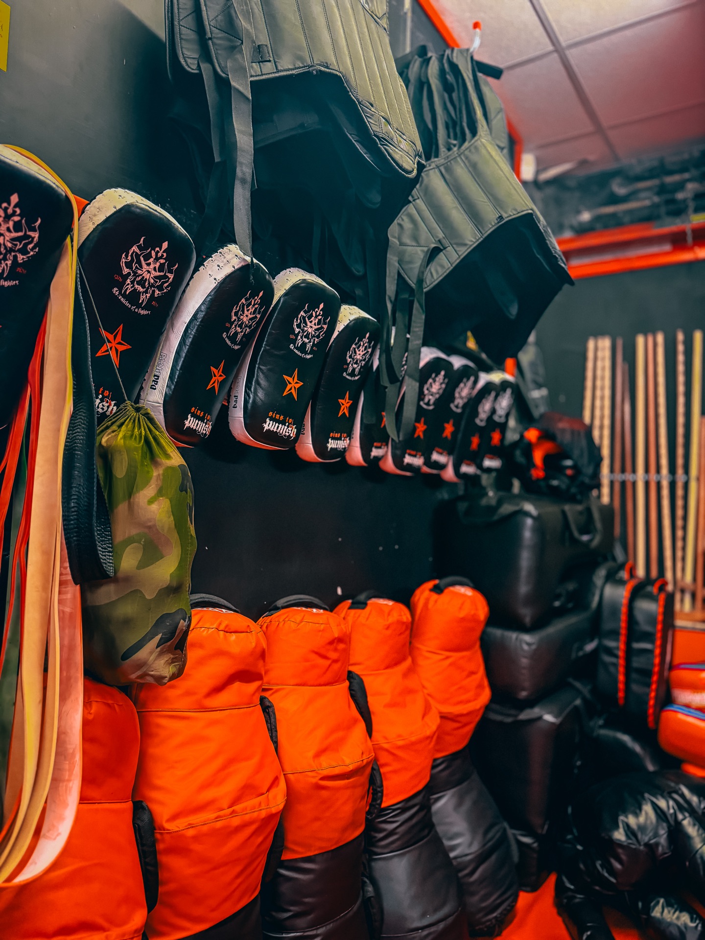 Rack of boxing gloves and focus pads at Genjitsu Martial Arts